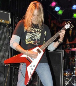 Carlos with his main live guitar, a stock Gibson Flying V (click to see it bigger).